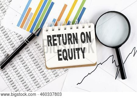 Return On Equity Text On A Notebook On The Graph Background With Pen And Magnifier