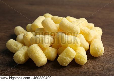 Pile Of Delicious Crispy Corn Sticks On Wooden Table, Closeup