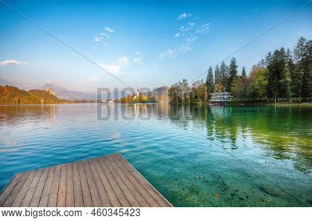 Splendid  Sunny Day View Of Popular Tourist Destination  Bled Lake. Dramatic View Of Pilgrimage Chur