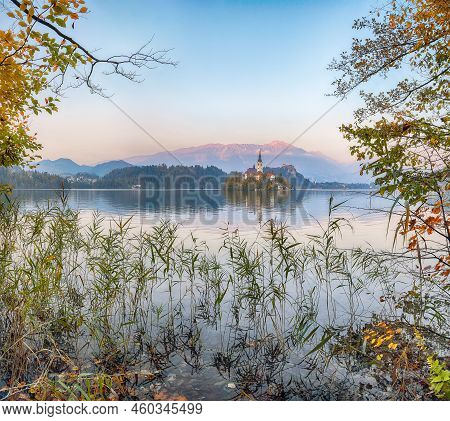 Amazing Sunset Over Popular Tourist Destination  Bled Lake. Dramatic View Of Pilgrimage Church Of Th