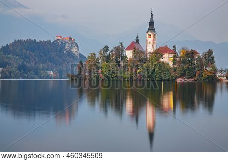 Stunning Sunset View Of Popular Tourist Destination  Bled Lake. Dramatic View Of Pilgrimage Church O