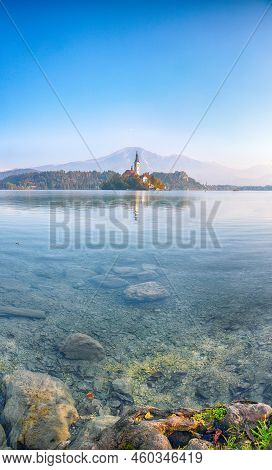Splendid  Sunny Day View Of Popular Tourist Destination  Bled Lake. Dramatic View Of Pilgrimage Chur