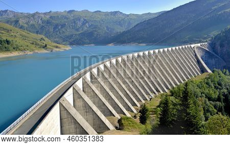 The Roselend Dam With Turquoise Water In A Mountainous Landscape In France