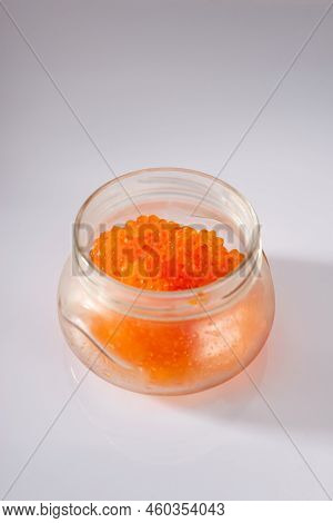 Side View Of Closed Glass Jar With Red Caviar Of Pink Salmon Isolated On White Background.