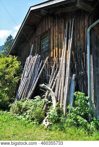 Wooden Shed On A Meadow Under A Blue Sky