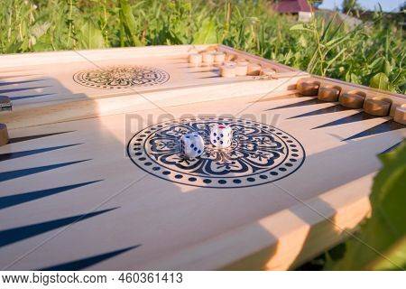 Throwing Dice In Backgammon Board Game Close Up. Foreground Soft Focus.