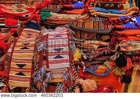 Display With Assortment Of Bright Red Orient Rugs With Traditional Ornamental Patterns In Middle Eas