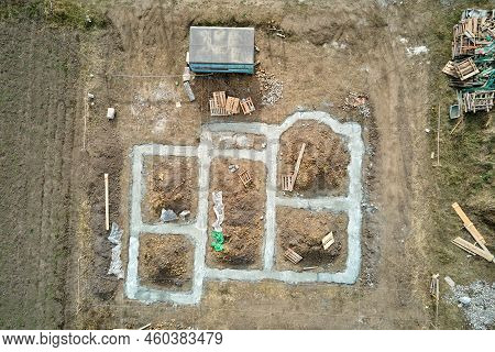 Top Down Aerial View Of Building Works Of New House Concrete Foundation On Construction Site.