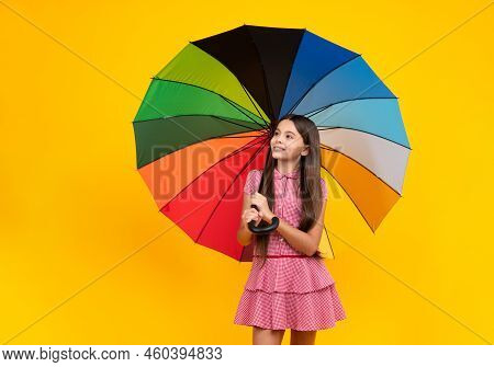 Summer Dress. Happy Teen Girl Holding Rainbow Umbella Standing Isolated On Yellow Background, Isolat