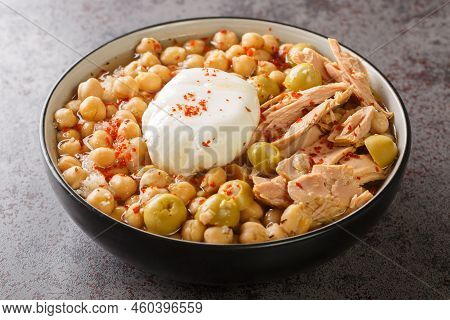 Lablabi Tunisian Spicy Chickpea Stew With Green Olive, Canned Tuna And Poached Egg Closeup In The Bo