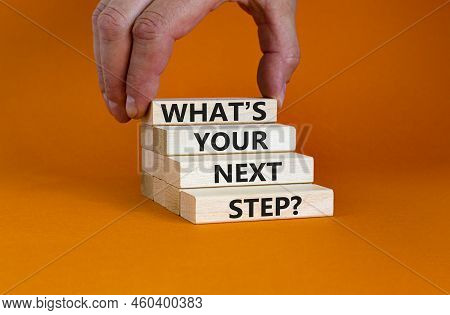 What Is Your Next Step Symbol. Concept Words What Is Your Next Step On Blocks. Businessman Hand. Bea