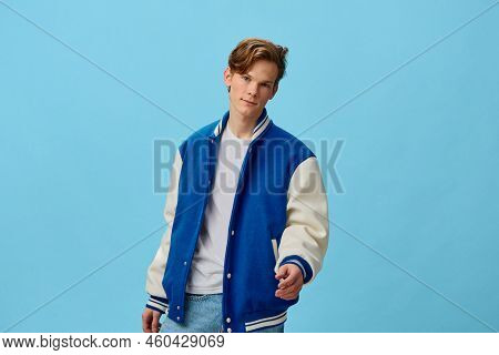 A Handsome, Attractive Young Man Student In A Trendy Bomber Jacket And Jeans Is Standing Friendly Ex