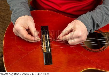 Replacement And Insertion Of Nylon Strings In A Classical Guitar. Lesson For A Musician