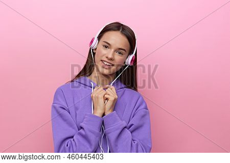 A Nice, Sweet Woman Is Standing In A Purple Tracksuit, Im Listening To Music In My Headphones With M