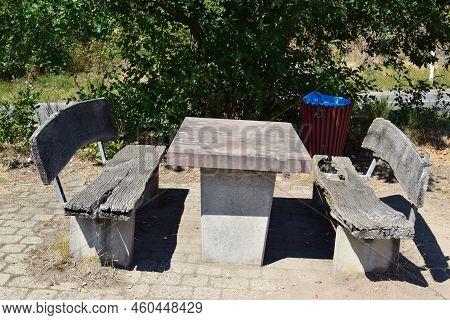 Table And Park Benches With A Big Hole