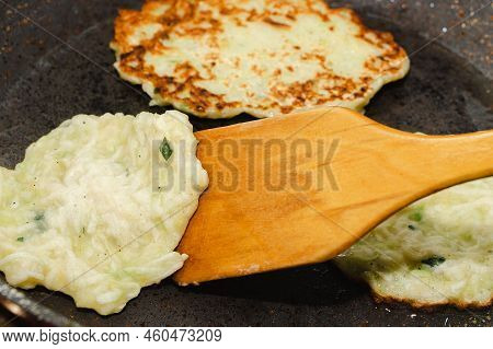 Recipe For Zucchini Fritters. Step 5 - Fry Pancakes In Pan Until Golden Brown. Flipping Pancakes Wit