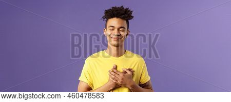 Always In My Heart. Touched, Carefree Handsome Young Man With Dreads, Yellow T-shirt, Close Eyes And