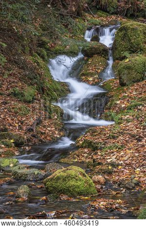 Beautiful Waterfall Landscape Image In Vibrant Autumn Woodland In Lake District