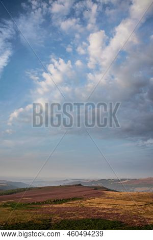Stunning Late Summer Sunrise In Peak District Over Fields Of Heather In Full Bloom Around Higger Tor