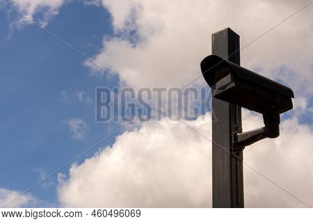 Close Up Of Pole Mounted Surveillance Camera Against Blue Partly Clouded Sky Concept Ccd Video Secur