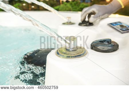 Worker Testing Garden Water Spa Features. Running Water Jets And Fountains.