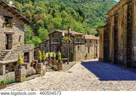 Old Houses Made Of Stone With Flowers And Decorative Objects In The Pretty Village Of Beget, Girona,