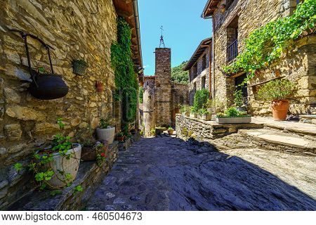 Picturesque Alley With Houses Made Of Stone And Pots With Flowers In The Medieval Village Of Beget, 