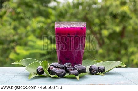 Jamun Or Black Plum Juice In A Glass With Fruit And Leaves Isolated On Wooden  Background With Copy 