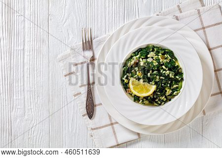 Spanakorizo, Greek Spinach And Rice Pilaf With Lemon, Dill, Scallion In White Bowl On White Textured