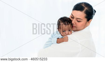 Close Up On Face Of 1-month-old Baby Newborn Son Is Half-african Halt-thai On Mother's Shoulder With
