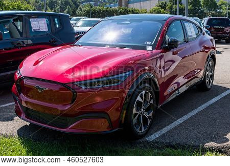 Monroeville, Pennsylvania, Usa August 28, 2022 A Used, Red Mustang Mach-e Premium Suv For Sale At A 