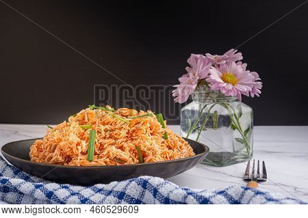Sweet And Sour Crispy Noodles Or Mee Krob In The Thai Language On A Dish With Cloth, Vase, Cutlery P