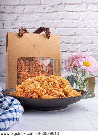 Sweet And Sour Crispy Noodles Or Mee Krob In The Thai Language On A Dish With Cloth, Vase Placed On 