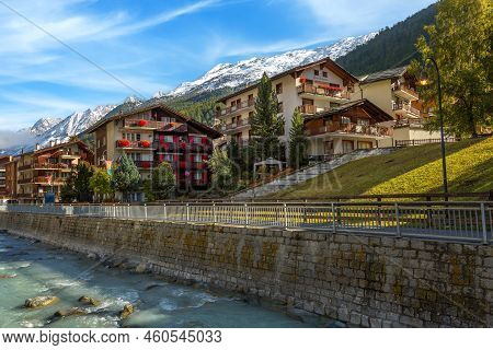 Zermatt, Switzerland - October 7, 2019: Town Street View In Famous Swiss Alps Ski Resort, River, Sno