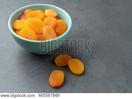 Dried Apricots On A Bowl Over Stone Background.