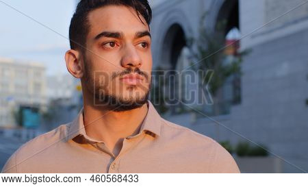 Close Up View Of Good Looking Hispanic Business Man In Shirt Looking Away Dreaming Standing In City 