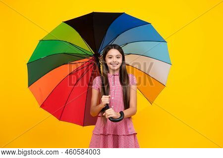Happy Teen Girl Holding Rainbow Umbella Standing Isolated On Yellow Background, Isolated On White. C