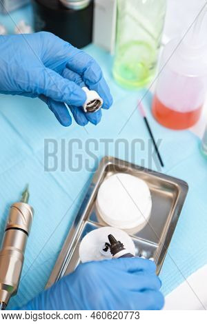 Hands And Working Accessories Of Tattoo Cosmetologist Preparing For Permanent Makeup Procedure In Be