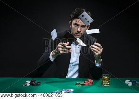 Expressive One Emotional Handsome Caucasian Brunet  Pocker Player At Pocker Table With Chips And Car