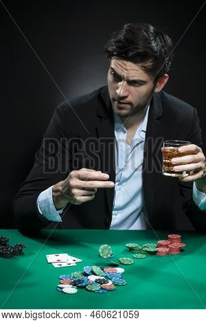 Expressive One Emotional Handsome Caucasian Brunet  Pocker Player At Pocker Table With Chips And Car