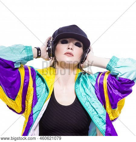 Closeup Portrait Of Young Caucasian Female  Sportwoman In Fitness Outfit And Baseball Cap With Wirel