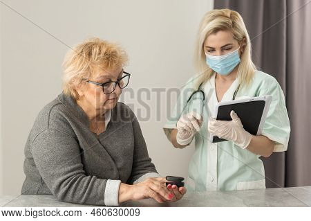 Hand Of Senior Woman With An Attached Pulse Oximeter On Fingertip, Old Elderly Measuring Heart Rate,