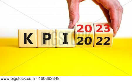 Kpi, Key Performance Indicator Symbol. Businessman Turns Wooden Cubes With Words Kpi 2022 And Kpi 20
