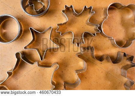 Cutting Out Cookies With Metal Mold From The Shortcrust Pastry. A Metal Forms In The Form Of Snowfla
