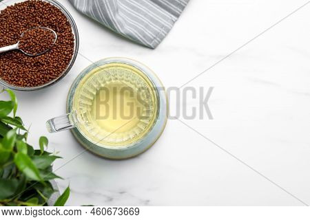 Cup Of Buckwheat Tea And Granules On White Marble Table, Flat Lay. Space For Text