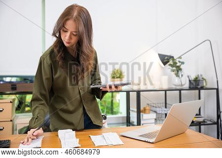 Asian Female Calculating Family Budget Financial And Accounting At Home, Young Woman Working With Fi