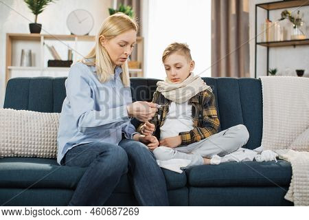 Family, Healthcare, Flu And Cold Concept. Stay At Home. Mother Taking Care Of Her Cute Sick Teen Boy