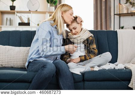 Mature Blond Woman, Checking Her Sick Boy Temperature On Thermometer After Measuring. Sad Ill Child,