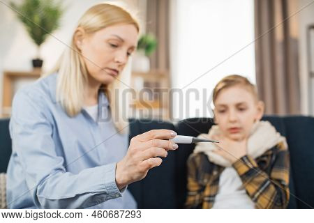Close-up Of Moms Hand, Holding Thermometer. Excited Pretty Mother Comforting Hugging Her Child, Chec