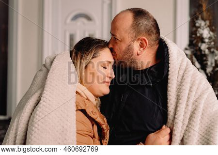 Close Up Photo Of A Loving Couple Outside Wearing Warm Clothes And Blanket Hygging Together And Man 